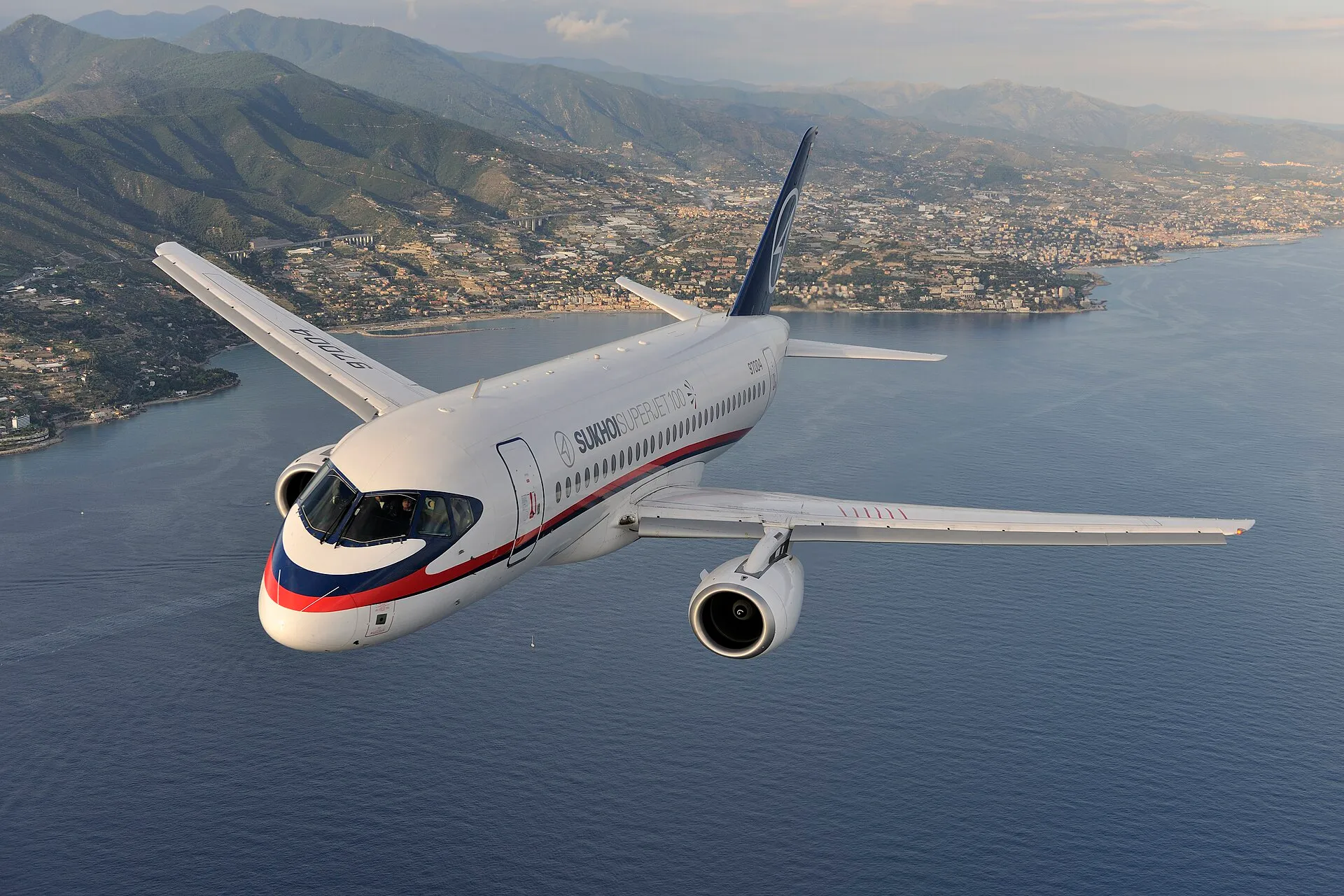 airplane flying over Mediterranean coast